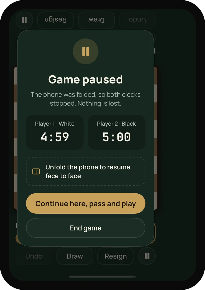 The cover screen after folding mid-game: “Game paused”, both clocks stopped, with options to continue as pass and play or end the game.